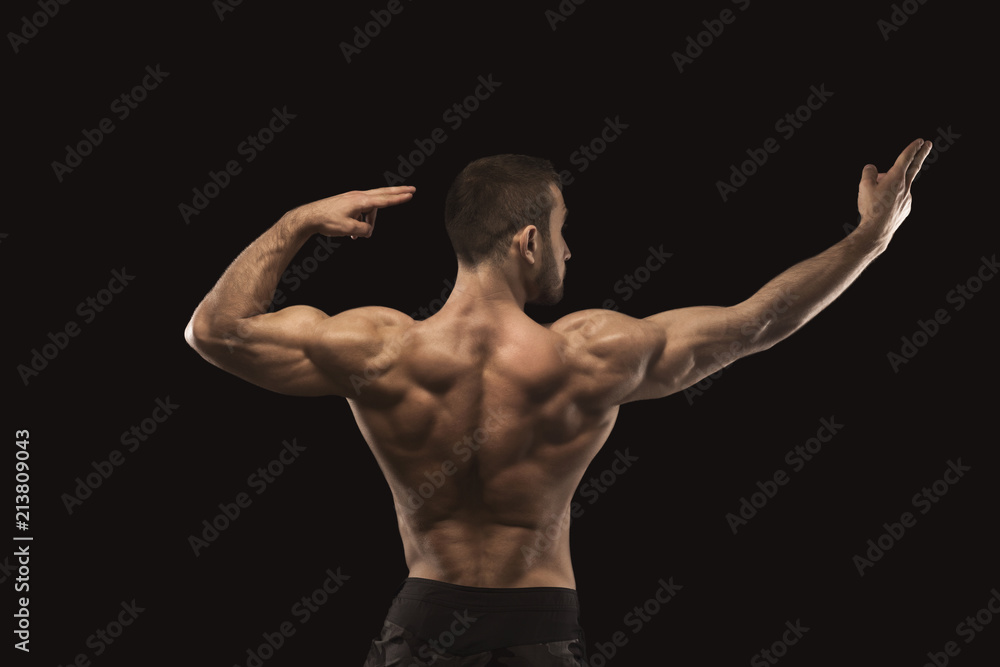 Strong athletic man showes naked muscular body Strong athletic man showes naked muscular body