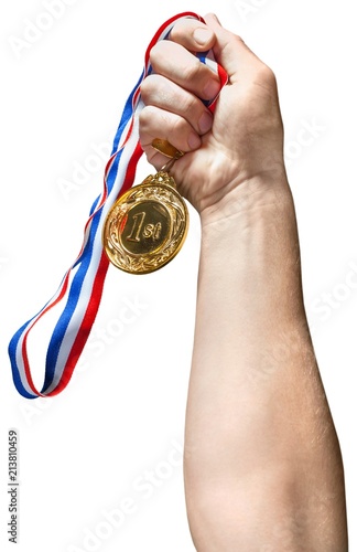 Hand Holding a Gold Medal