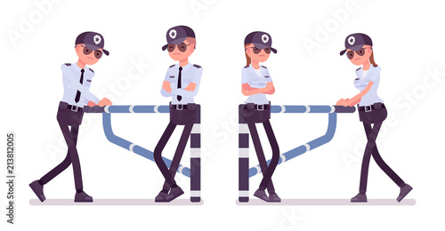 Male and female security guard at mechanical barrier