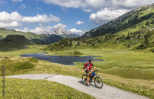 active senior woman, riding her e-mountainbike in the Arlberg area near Lech,Tirol,Austria