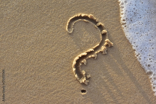 A question mark drawn on the sand of a beach. Who is there ? What do I need?