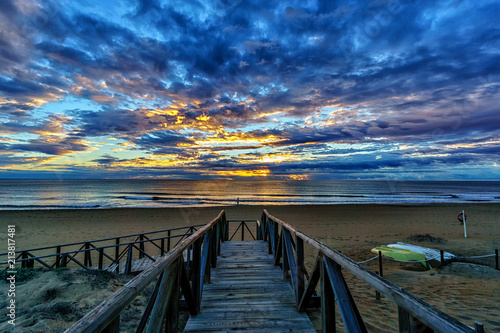 Fototapeta Naklejka Na Ścianę i Meble -  Sunrise over the Mediterranean sea with a wooden board walk