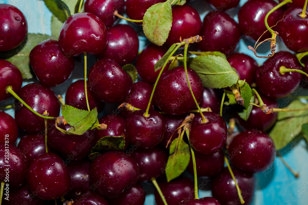 Closeup of ripe cherries with stalks. Large collection of fresh red cherries. Ripe cherries background. Closeup of ripe cherries with stalks. Large collection of fresh red cherries. Ripe cherries background.