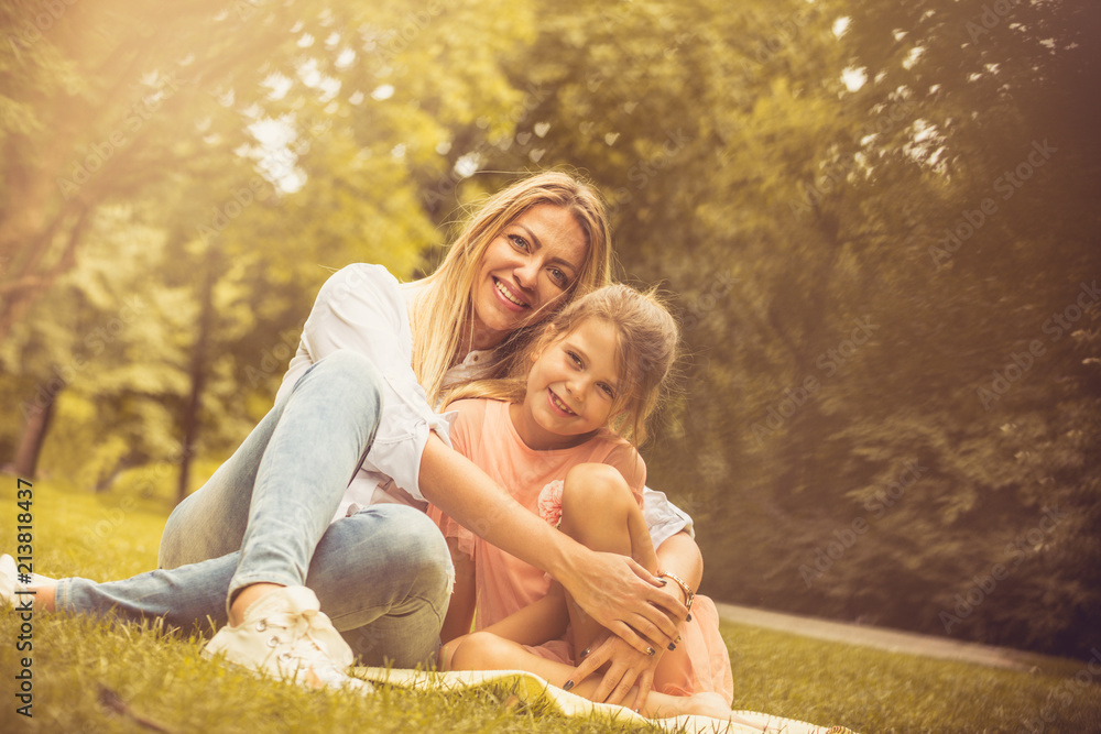 Fototapeta premium Portrait of Mother and daughter at nature.