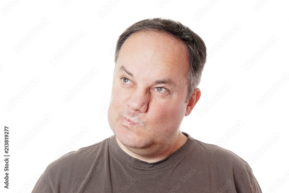 skeptical middle aged man making a face and twisting his mouth skeptical middle aged man making a face and twisting his mouth