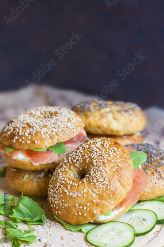 Homemade bagels with cream cheese and cured salmon. Dark background.