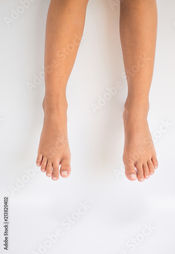 Fototapeta Naklejka Na Ścianę i Meble -  Legs and feet with white backdrop