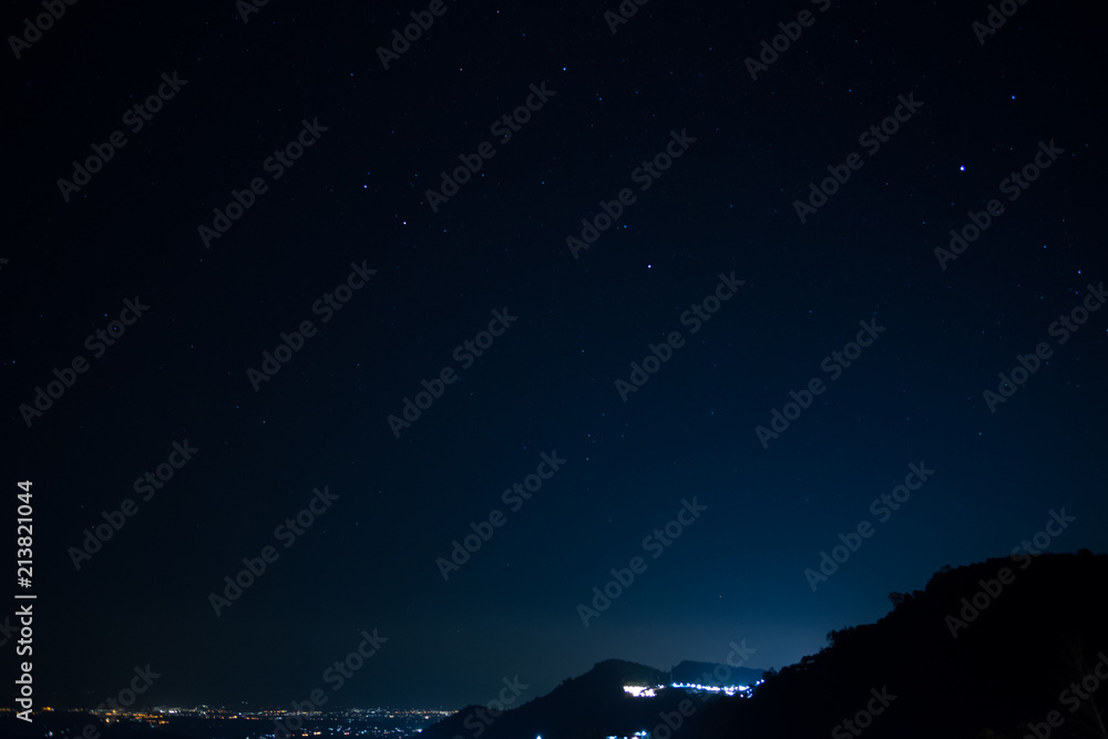 Star and mountain on the night sky.