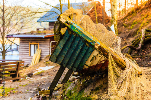Old, dirty piece of boat covered in net