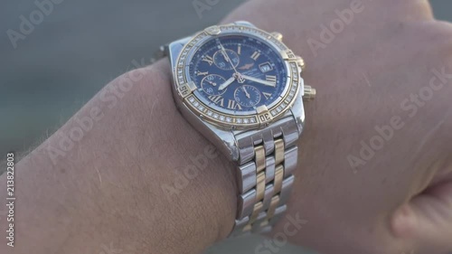 Businessman checking wrist watch. The watch on the hand. Men's Accessories
