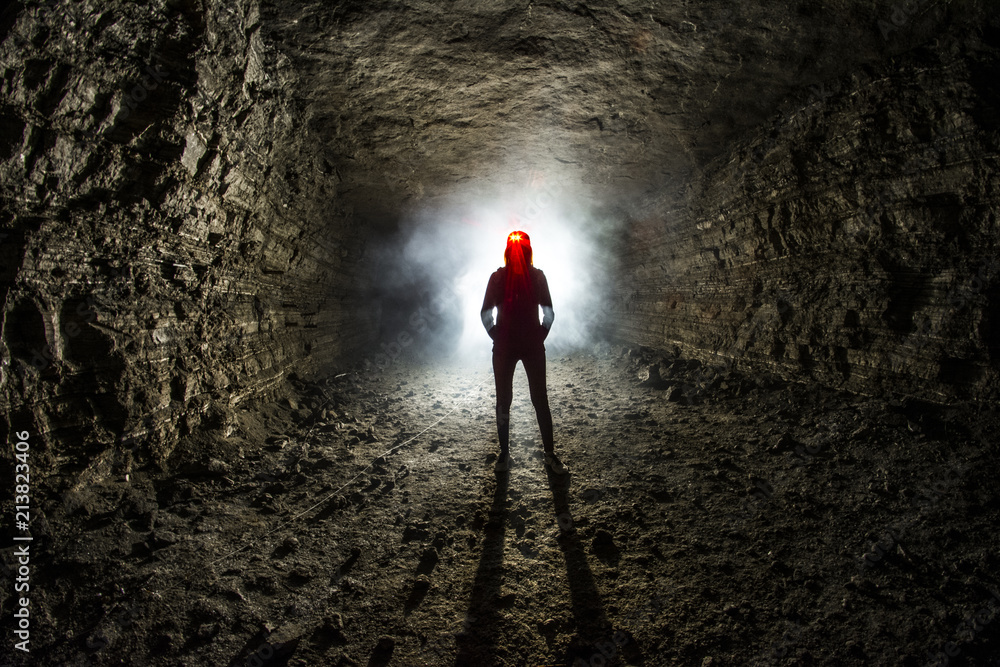women stand in abandoned mine