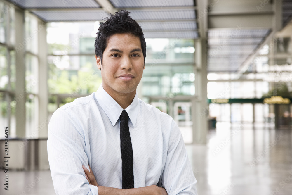 Portrait of a businessman in the lobby of a convention center. Portrait of a businessman in the lobby of a convention center.