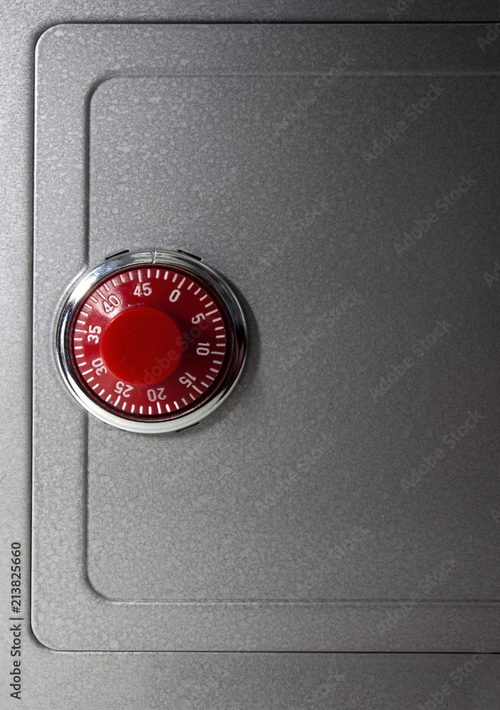 Toy metal safe with red combination lock. Isolated. Toy metal safe with red combination lock. Isolated.
