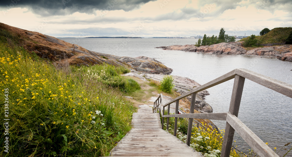 Wooden paths stairs along the coast on the island of Suomenlinna, a beautiful seascape. Islands of Finland