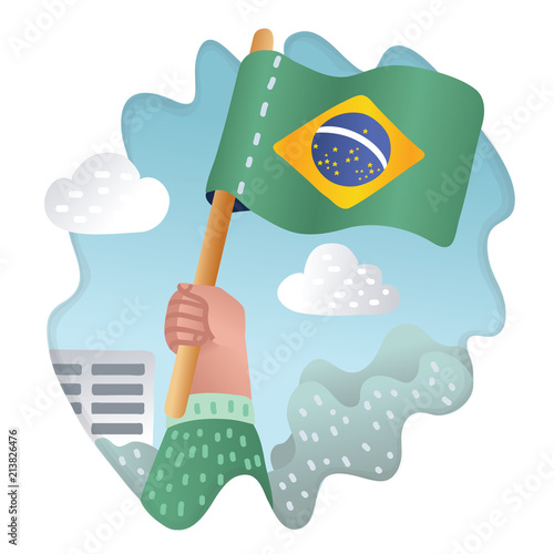 Hand holding, raising the national flag of Brazil