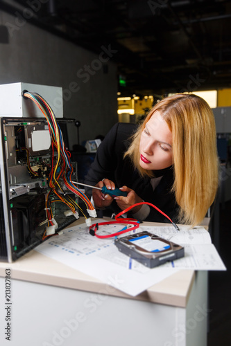 Photo of woman at table next to broken processor