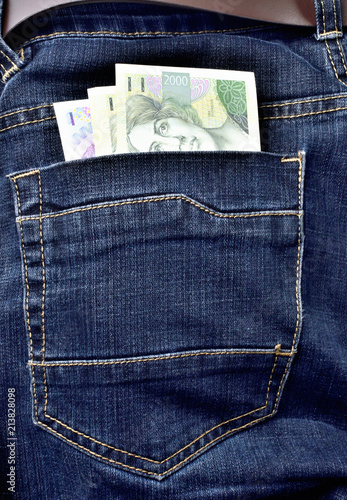 Back pocket of jeans full of czech banknotes, czech crowns - vertical photo