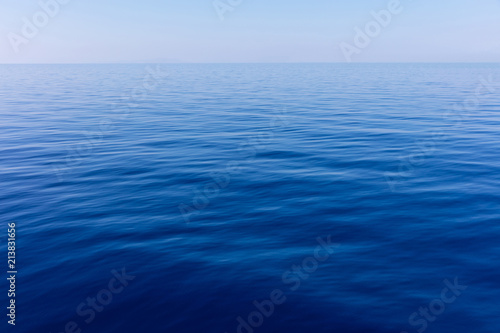 Blue sky and calm ocean sea water background © Rawf8