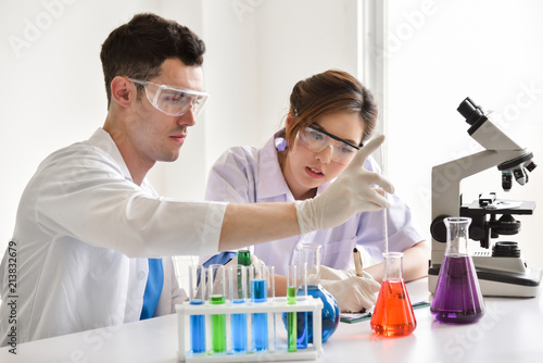 Two scientists are working in laboratory.