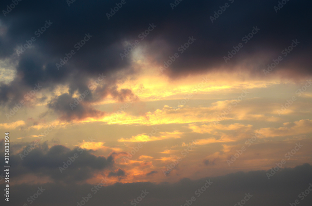 Dramatic light mood with orange illuminated clouds during a sunrise over the Baltic Sea in Bansin on usedom, Germany