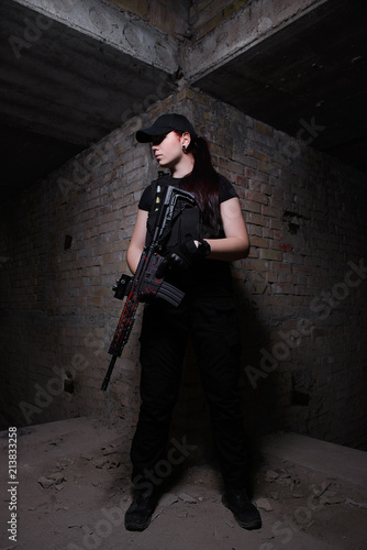 Armed girl in dark room