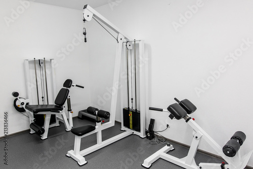 modern gym weight training equipment for exercises and rehab for legs and back. rehabilitation equipment in therapy clinic. fitness wellness concept. space for text