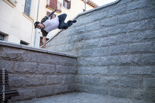 Photography Young man doing an amazing parkour trick on the street.