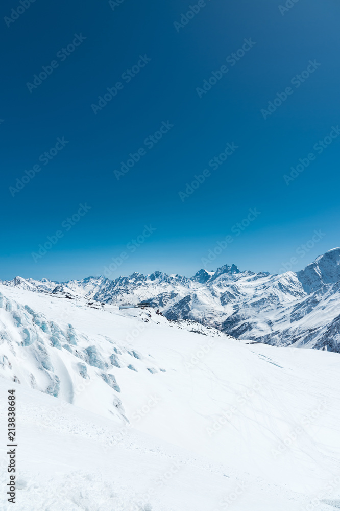 Winter snow covered mountain peaks in Caucasus. Great place for winter sports