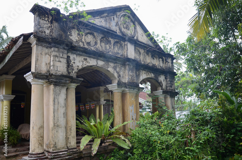 Aluthgama, Sri Lanka - May 04, 2018: Exterior view of the old house with columns of 1898 year of construction in Sri Lanka photo