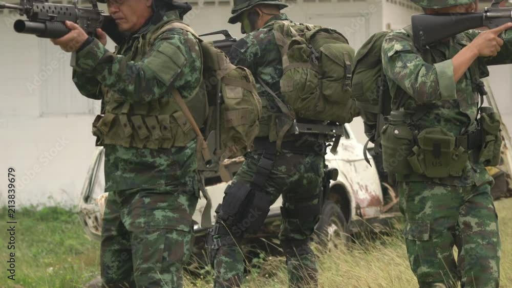 Soldier holding gun weapon and waring armor uniform. The military is responsible for maintaining the territory. Soldier holding gun weapon and waring armor uniform. The military is responsible for maintaining the territory.