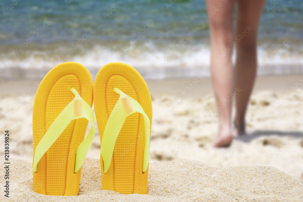 Fototapeta premium beach scenery with sandals in the sand