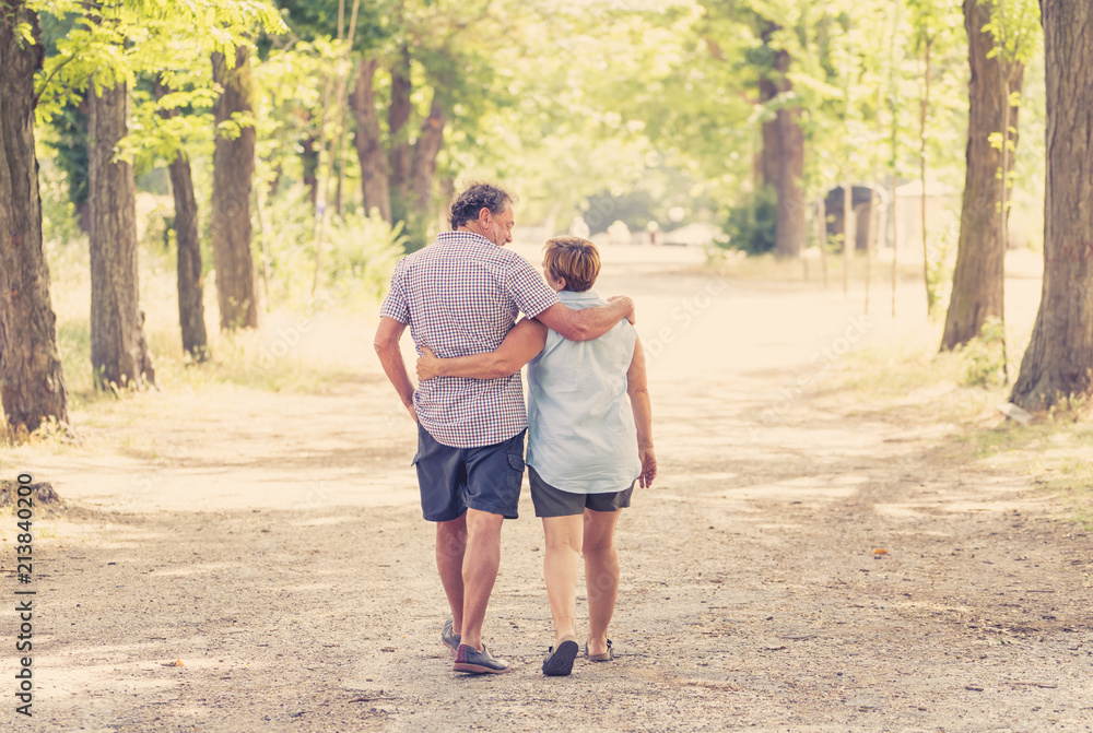 Happy senior couple walking and enjoying life outdoors