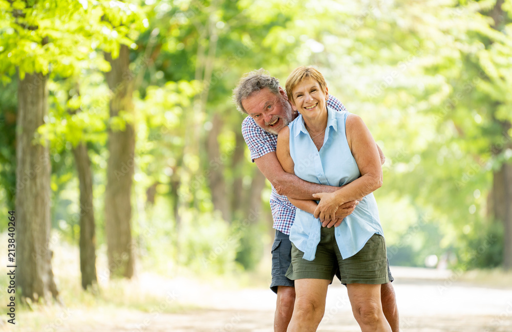 Portrait of a beautiful happy senior couple in love relaxing in the park