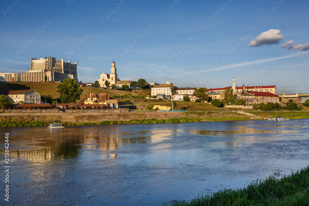 panorama of evening in the old town on the bank of a wide river
