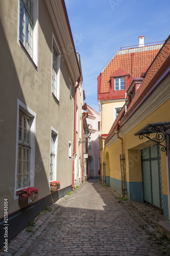 Old buildings and narrow and empty street on Toompea Hill at the Old Town in Tallinn, Estonia, on a sunny day in the summer.