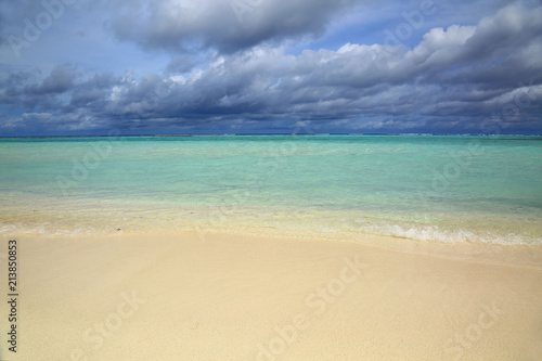 Gorgeous view of Indian Ocean, Maldives. White sand coast line, turquoise ocean water and blue sky with white clouds. 