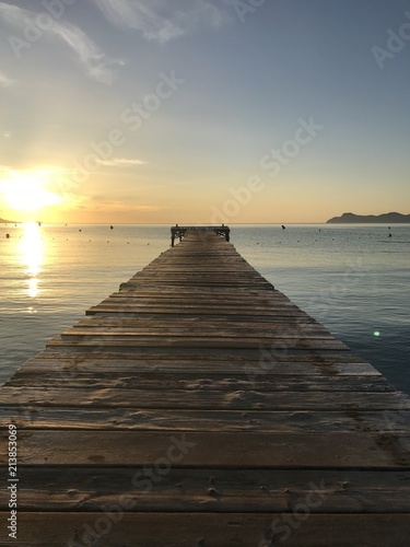 Beautiful sunrise from a wooden pier by the sea