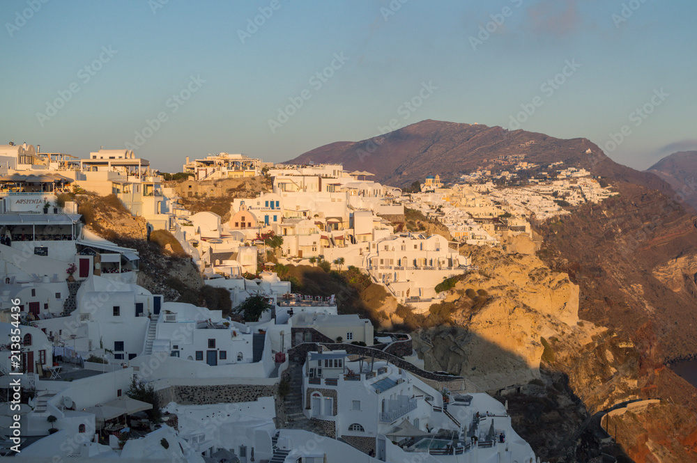Whitewashed Houses on Cliffs with Sea View and Sunset in Oia, Santorini, Cyclades, Greece