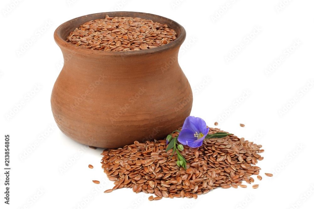 clay pot with flax seeds and flower isolated on white background. flaxseed or linseed. Cereals. clay pot with flax seeds and flower isolated on white background. flaxseed or linseed. Cereals.