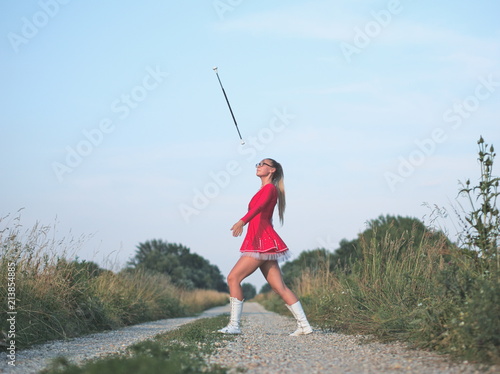 Teen Majorette Girl Twirling Baton Outdoors