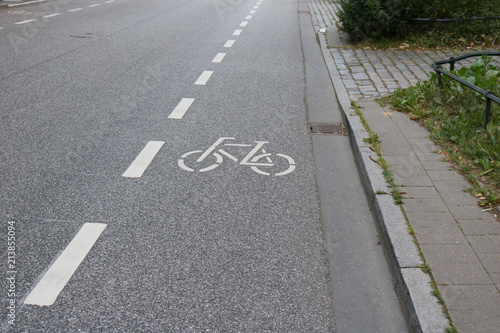 Marked bicycle lane on a paved, concrete road in Germany, no people.