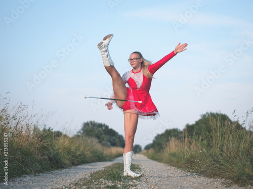 Teen Majorette Girl Twirling Baton Outdoors