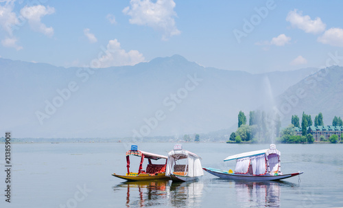 Tourist barges for romantic escapes on Srinagar Lake, a popular travel destination in Kashmir, India photo