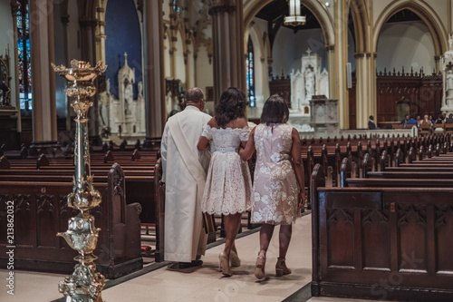 NEW YORK CITY, USA - July 10, 2018: bride with her family going to ceremony in catholic church