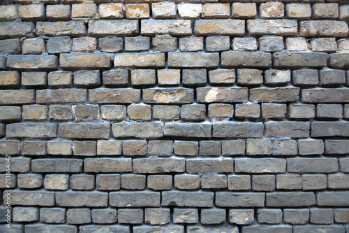 old wall of gray brick 