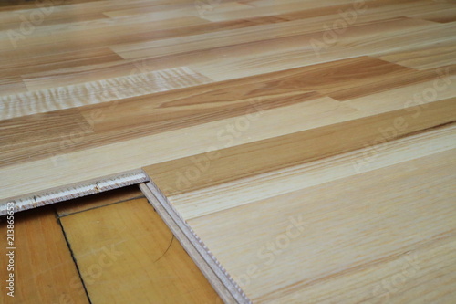 An image of an old parquet and a new parquet board.