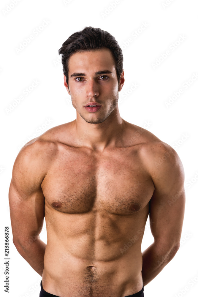 Handsome shirtless athletic young man in jeans, looking at camera in studio shot, isolated on white background