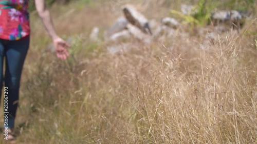 Wallpaper Mural Woman walking towards camera through a field of wild wheat.  Shot on a Blackmagic Ursa Mini Pro 4.6k with a Sigma 50-100mm f/1.8. Torontodigital.ca