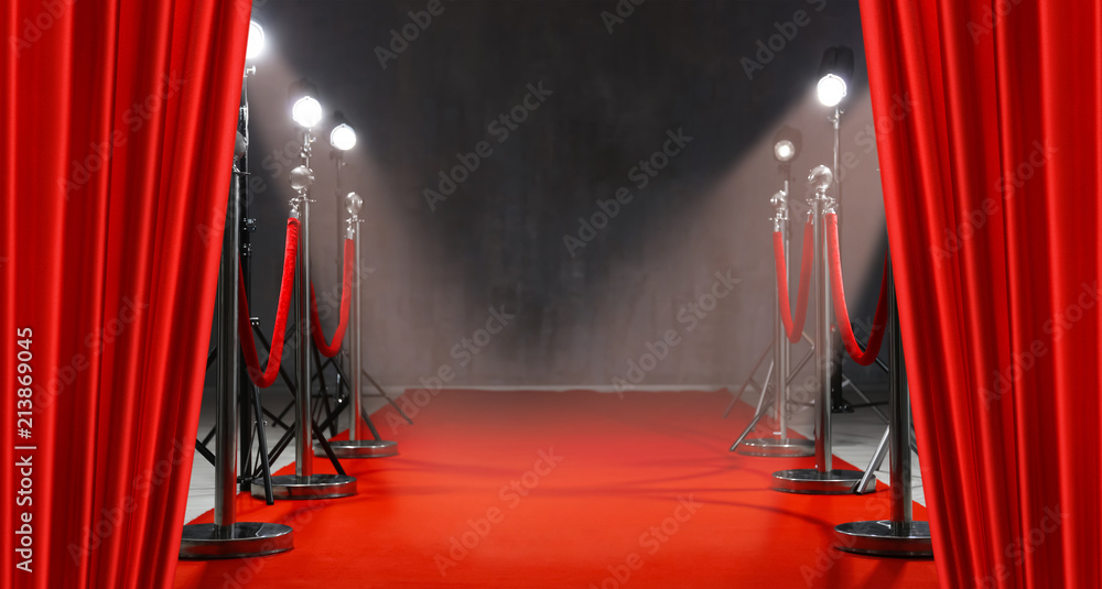 Red carpet, rope barriers and spot lights behind curtains indoors - obrazy, fototapety, plakaty 
