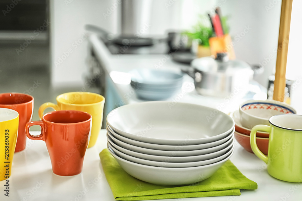 Fototapeta premium Shelving with different clean dishes in kitchen